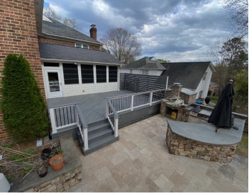 view of the back of a home with a wraparound porch and patio