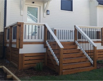 the back of a home with a simple wooden deck