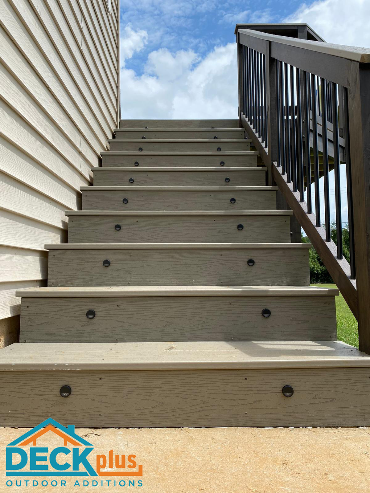 Custom low-maintenance deck with custom rail and integrated stair lighting. 