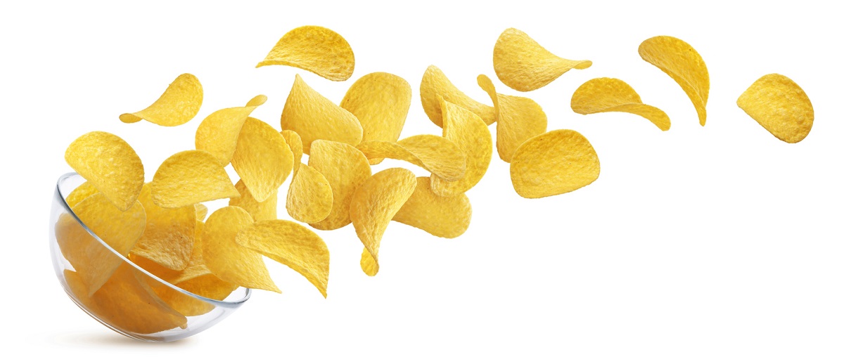 A bowl of potato chips spilling