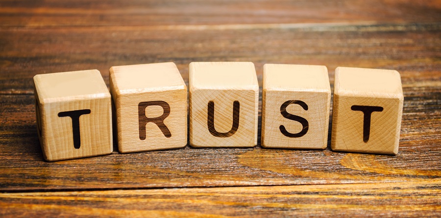 Wooden letter blocks that spell out 'trust'