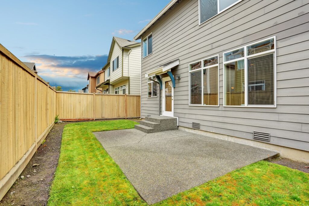 A backyard with concrete stairs and patio