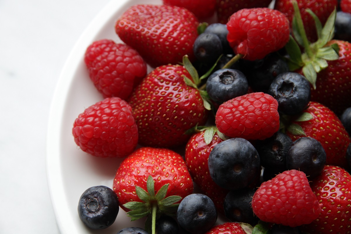 A bowl of strawberries, blueberries, and raspberries