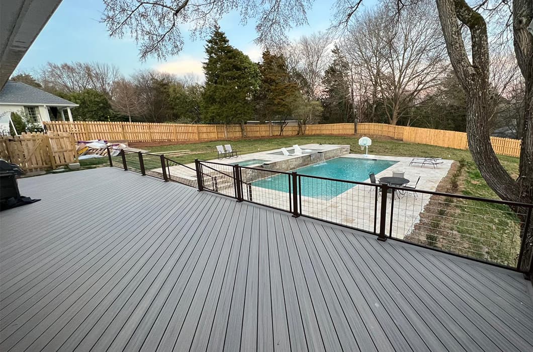 A deck with a decorative diagonal pattern and wire railing