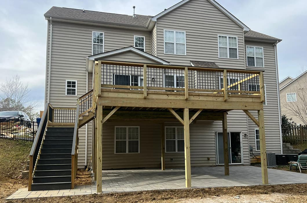 a house with an elevated deck and stairs