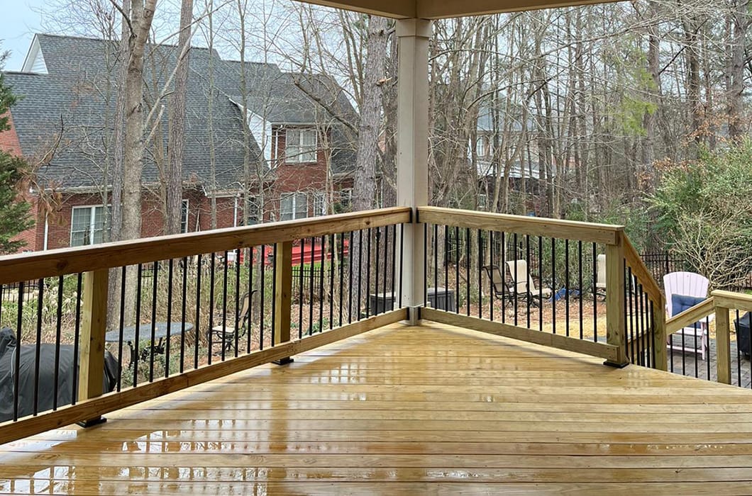 a wooden deck with iron railings