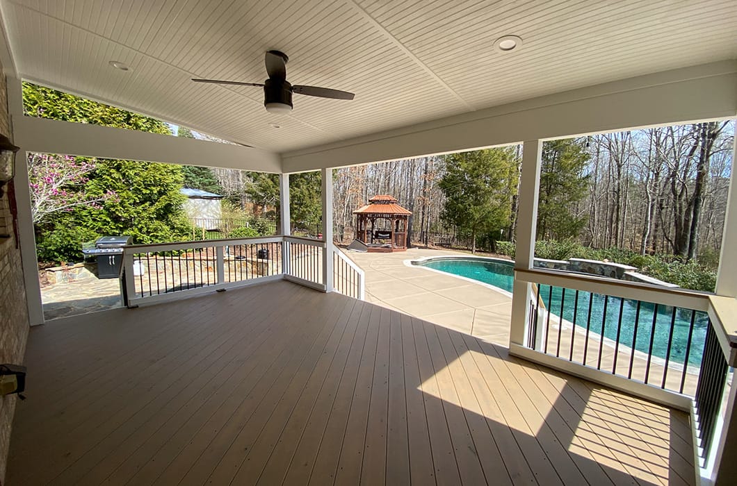A deck that leads out to a pool and gazebo
