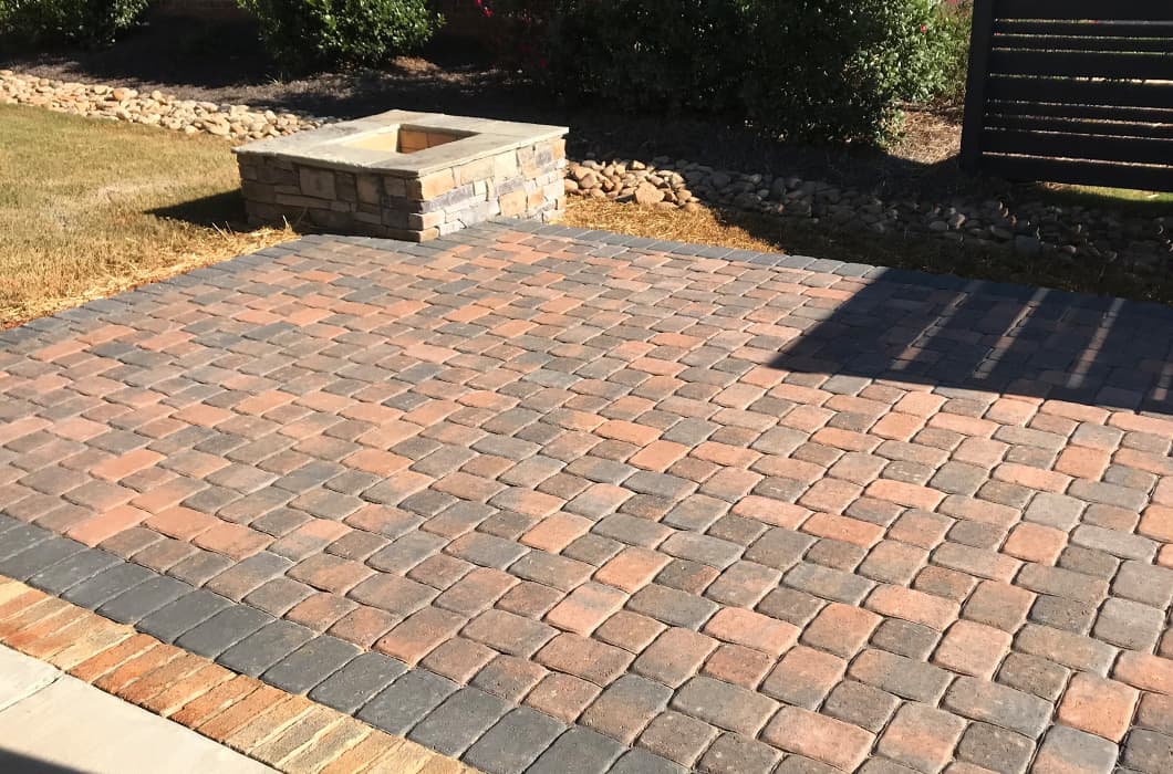 a brick patio with a fire pit