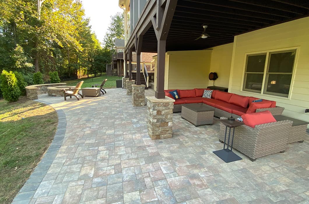 an outdoor patio with seating and fire pit
