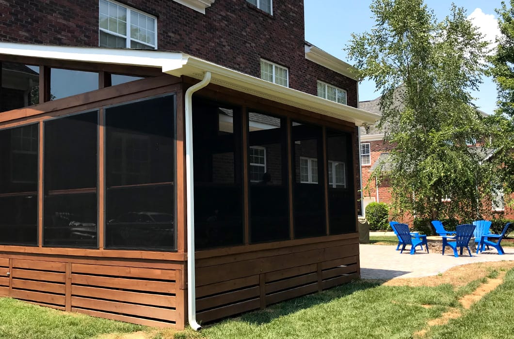 three-season room that leads onto a patio with a firepit