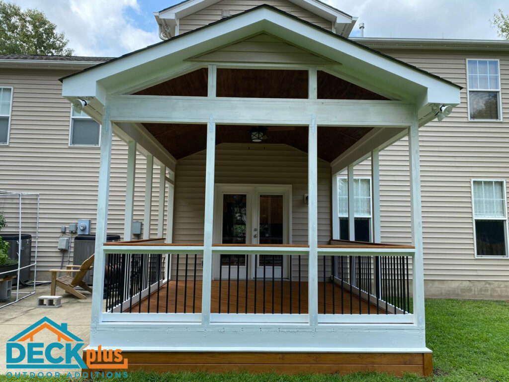 Screened-in porch addition on the back of a large tan home with pale blue trim.