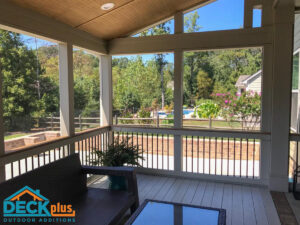 Screened porch with shed roof. Deck Plus logo in bottom left corner.